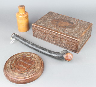 A circular carved wooden plaque marked Royal Sussex County Hospital 1823 8", a rectangular Indian carved hardwood writing box with hinged lid marked Subedar Manta Singh 1915 3 1/2" x 12" x 8" (some inlay and interior missing), a cylindrical turned wooden bottle case 7" x 3" and a sheleighleigh 15" 