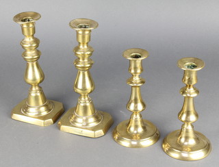 A pair of 18th/19th Century brass candlesticks with ejectors 7" together with a pair of late 19th Century candlesticks with ejectors