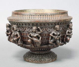 A circular carved Eastern hardwood bowl decorated figures of female musicians raised on a circular spreading foot 7" x 10" 