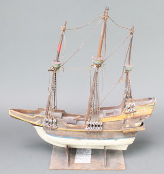 A 1930's model of The Mayflower together with a short history of the building of the boat, raised on a wooden stand 19"h x 18"w x 3"d 