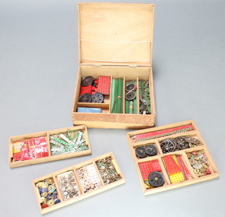 A wooden box containing a collection of green, red and steel coloured Meccano contained in 3 trays 