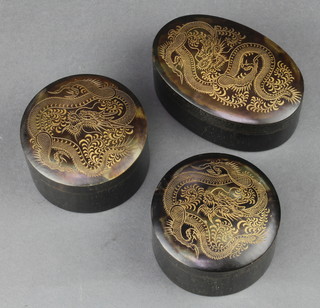 A pair of 1930's cylindrical simulated tortoiseshell jars and covers the lids decorated dragons 1 1/2" x 3" and an oval ditto 1" x 3 1/2" x 2 1/2" 