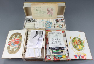A collection of cigarette cards, an album of Players cigarette cards - motorcars, do. Wills wild flowers and a box of wine bottle and luggage labels 