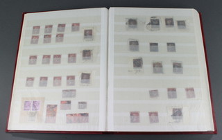 A red stockbook of GB and Ireland stamps - Victoria to Elizabeth II including tuppenny reds and blues 