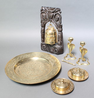 A Japanese gilt metal table bell hung from a hardwood stand 15" x 8" with brass beater, a Japanese circular metal charger decorated dragons 15", 2 Benares brass cylindrical jars and covers 3" x 5 1/2" and a pair of brass cobra candlesticks 6" 