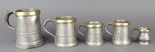 A Victorian pewter pint measure with brass band, ditto pint measure marked Rich Hanwell, 2 ditto half pints and a baluster shaped half gill 
