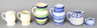An Ashtead Pottery banded jug with blue and green decoration 7", a blue ditto 6 1/2", a milk jug 4 1/2", a baluster cream ditto 4 1/2", a lidded jug 5" and a cream jug 2 1/2" 