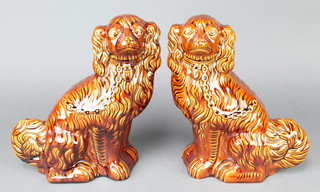 A pair of Victorian style brown glazed figures of seated Spaniels 12" 