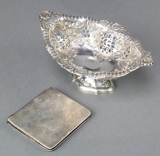 A Victorian pierced and repousse silver oval bon bon dish Chester 1898, 74 grams and a silver mounted wallet 