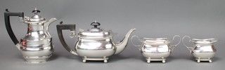 A 4 piece silver tea and coffee set of rounded rectangular form on ball feet with ebony mounts Birmingham 1923, gross weight 1581 grams 