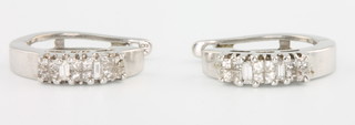 A pair of 18ct white gold diamond set ear clips 
