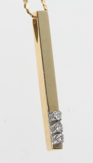 An 18ct yellow gold diamond set pendant and chain