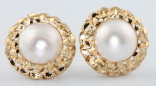A pair of 9ct yellow gold circular pearl set ear studs 