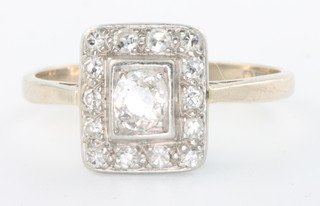 An 18ct white gold Art Deco style ring with centre old cut stone surrounded by 14 brilliant cut diamonds, size Q 