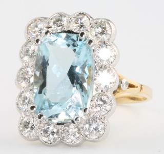 An 18ct yellow gold aquamarine and diamond rectangular cluster ring, the centre stone approx. 4.5ct surrounded by 14 brilliant cut diamonds 1.7ct size O 1/2