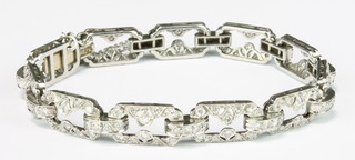 A good  Art Deco platinum and diamond 11 plaque open bracelet set with 4 stone links, approx 2.75ct
