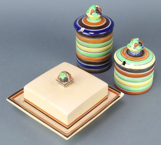 An Ashtead Pottery square cheese dish and cover 7 1/2", a preserve pot with banded decoration 5" and a ditto 6 1/2" 