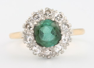 An 18ct yellow gold tourmaline and diamond cluster ring, the centre stone flanked by 10 brilliant cut diamonds, size Q