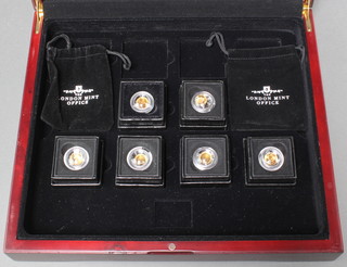 Six 22ct commemorative coins, each 0.5 grams, boxed