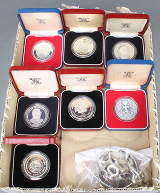 Seven silver commemorative medallions, 2 coin bracelets, a necklace and bangle, 117 grams