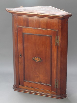 A Georgian mahogany  corner cabinet with moulded cornice, fitted shelves enclosed by a panelled door with brass H framed hinges 38"h x 30"w x 18 1/2"d 