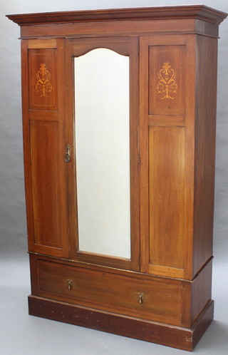 An Edwardian inlaid mahogany wardrobe with moulded cornice enclosed by arched bevelled plate panelled mirrored door, the base fitted 1 long drawer 79"h x 51"w x 19 1/2"d  