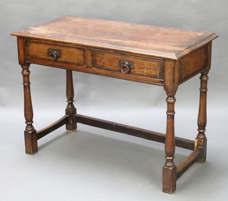 An 18th Century style oak side table, the top  formed of 4 planks, fitted 2 frieze drawers and raised on turned and block supports 30"h x 42"w x 21"d 