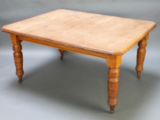A Victorian bleached oak extending dining table raised on turned supports with ceramic casters 29"h x 47"w x 57"d 