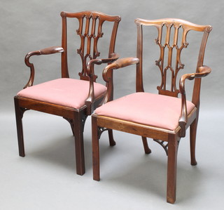 A pair of Chippendale style mahogany splat back carver chairs with upholstered drop in seats, raised on square tapering supports 