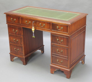 A mahogany pedestal desk with green inset writing surface, fitted 1 long and 8 short drawers, raised on bracket feet 30"h x 42"w x 21"d 