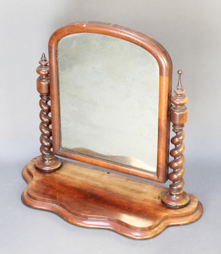 A Victorian arched plate dressing table mirror contained in a mahogany frame of serpentine outline  with spiral turned columns to the side 26 1/2"h x 37"w x 12"d 