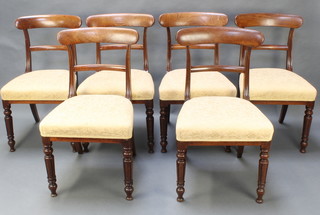 A set of 6 Georgian mahogany bar back dining chairs with over stuffed seats, raised on turned and fluted supports