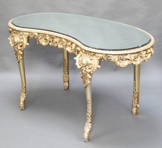 A French style kidney shaped dressing table with bevelled plate mirrored top, fitted a frieze drawer and raised on cabriole supports 30"h x 64"w x 26"d 