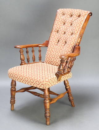 An American mahogany show frame armchair with spindle decoration raised on turned supports with H framed stretcher