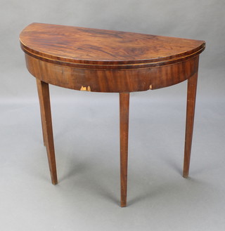 A Georgian mahogany demi-lune tea table raised on square tapered supports 29"h x 36"w x 18"d 