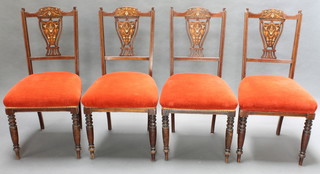 A set of 4 Edwardian inlaid mahogany splat back dining chairs with upholstered seats, raised on turned supports 
