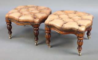 A pair of Victorian style shaped mahogany stools upholstered in brown buttoned leather, raised on turned and reeded supports with brass caps and casters 13" x 19" x 19" 