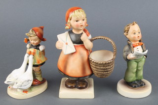 A Hummel figure of a girl with basket 6", do.  boy singing from a hymn sheet 5" and a girl with geese 47/3/0 