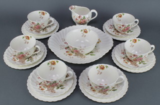 A Clarice Cliff Chelsea Rose pattern tea set comprising 6 tea cups, 6 saucers, 6 small plates, a sandwich plate, milk jug, sugar bowl 