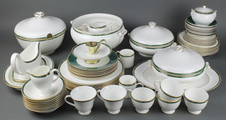 A Wedgwood Chorale pattern tea coffee and dinner service comprising 2 coffee cans, 4 small tea cups, 2 large tea cups, 8 saucers, 8 small plates, 8 medium plates, 8 dinner plates, 8 dessert bowls, 8 soup bowls, 2 tureens and covers, a soup tureen, a bowl and cover,  2 sauce boats and stands, 2 serving plates, milk jug, cream jug and chamber stick 