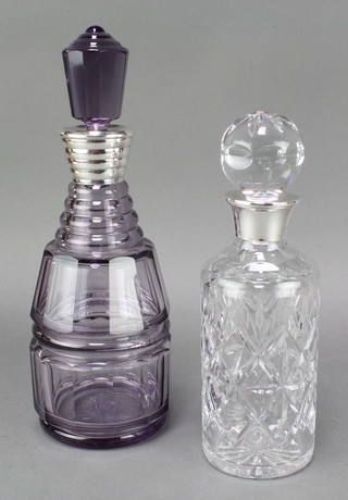 An amethyst faceted cut glass decanter and stopper with Continental silver rim 12" together with a cylindrical cut glass decanter and stopper with silver rim Birmingham 1981 10" 