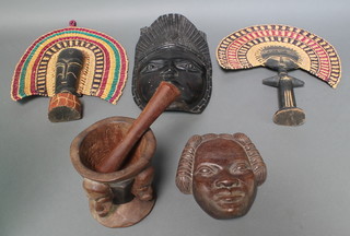 An Ashanti fertility doll with woven cane head piece 18", 1 other similar figure 15", 2 carved masks and a carved African mortar and pestle 
