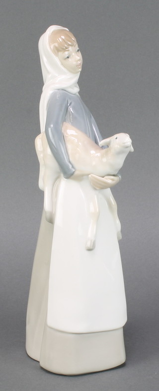 A Lladro figure of a young lady carrying a lamb 11" 