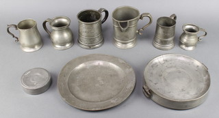 A circular pewter charger with London touch mark 9 1/2" (some pitting), a circular pewter plate warmer with London touch mark 8", do. jar and cover 5", a Victorian spouted pewter 1 pint measure the base marked Prince of Wales ..., a pint tankard marked A Handing King William East Street, a Victorian pewter half pint baluster shaped tankard, 1 other and a gill measure