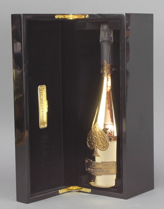 A 75cl bottle of Armand de Brignac Ace of Spades champagne Brut contained in a lacquered box with a limited edition plaque, the bottle embossed 10. 