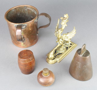 A bronze wedge shaped cow bell 5", an Art Nouveau style twin handled copper measure 5" x 4 1/2", a brass curtain tie in the form of a griffin and a Continental light in the form of a grenade