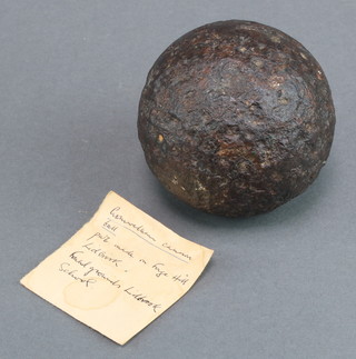 A 2" iron cannon ball together with a slip of paper marked Cromwellian cannon ball made on Forge Hill Lidbrook, found in the grounds of Lidbrook School 
