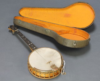 A  Windsor Whirl 4 stringed banjo complete with key contained in a carrying case  