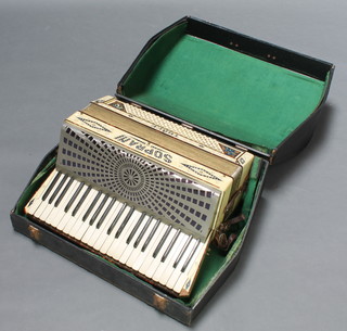 A Soprani Three accordion with 120 buttons contained in a fibre carrying case 
