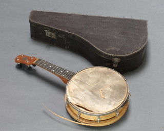 A 4 stringed banjo, the head marked John Grey (requires attention) complete with carrying case 